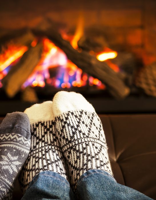 Feet-wearing-socks-to-keep-warm-and-fire-pit-in-living-room