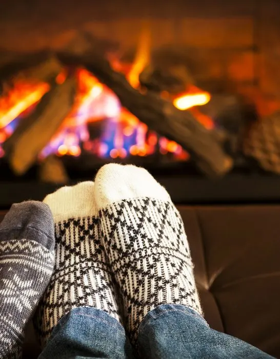 Feet-wearing-socks-to-keep-warm-and-fire-pit-in-living-room