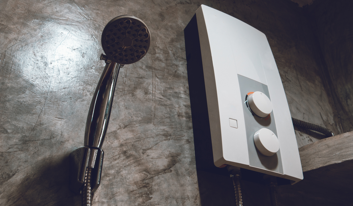 Tankless-water-heater-and-shower-head-on-cement-wall