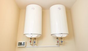 two big electric water heaters on the wall