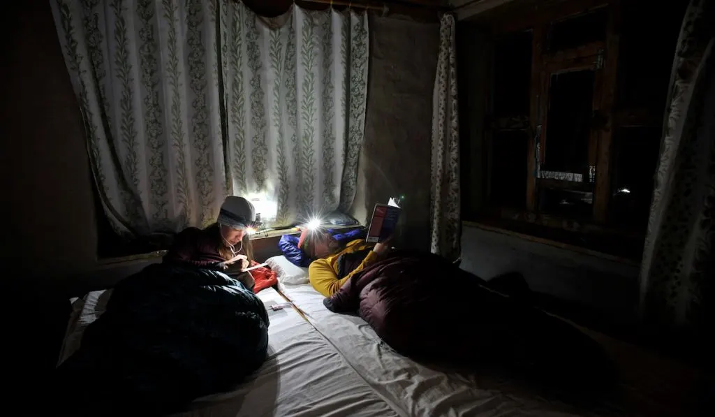 Couple in room in sleeping bags during power outage 