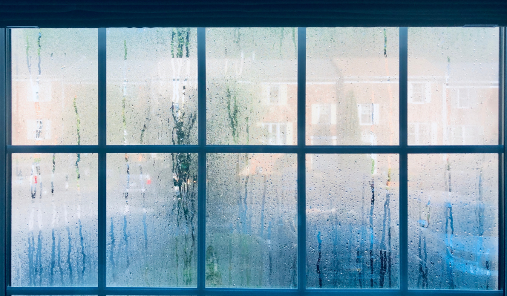Steamed up window from humidity and heat after summer storm
