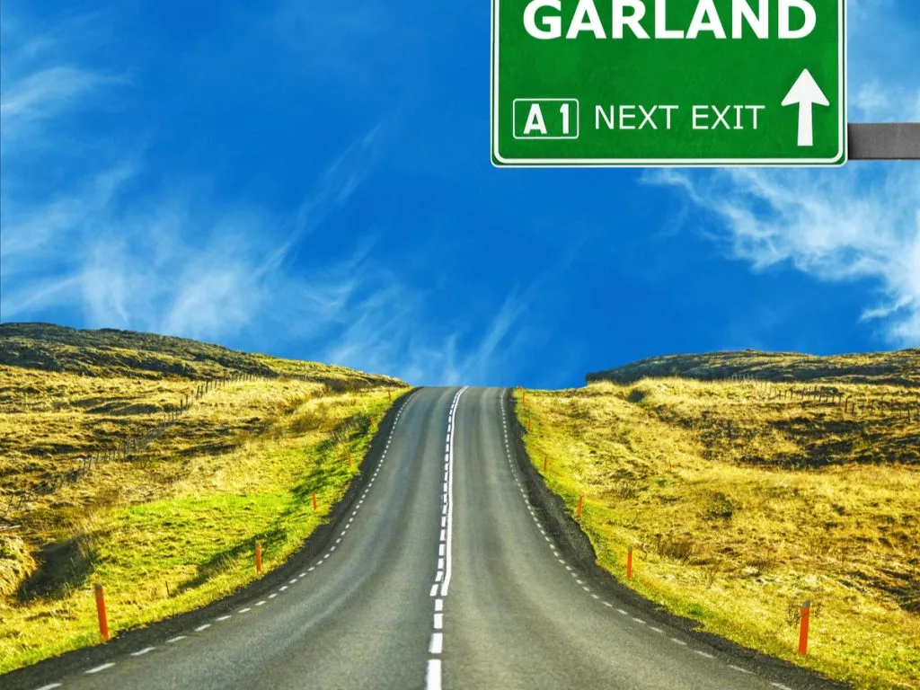 garland road sign against clear blue sky