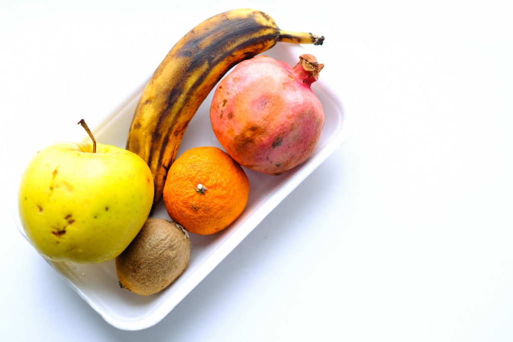 spoiled fruits on a white plate 