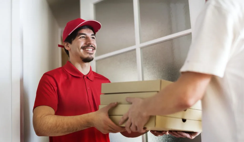 Man delivery pizza to customer
