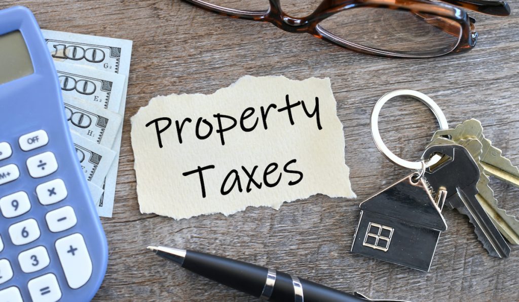 Property Taxes Flat Lay with keys, glasses and money
