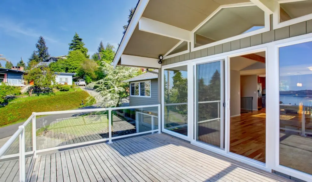 Balcony house exterior with glass railings and perfect view.
