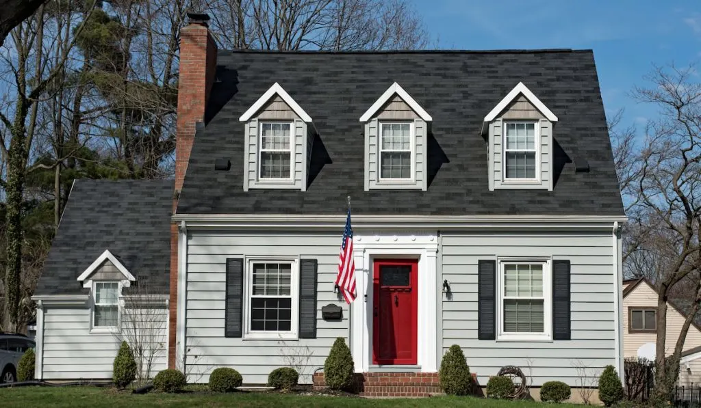 Cape Cod House with Three Dormers & Red Door