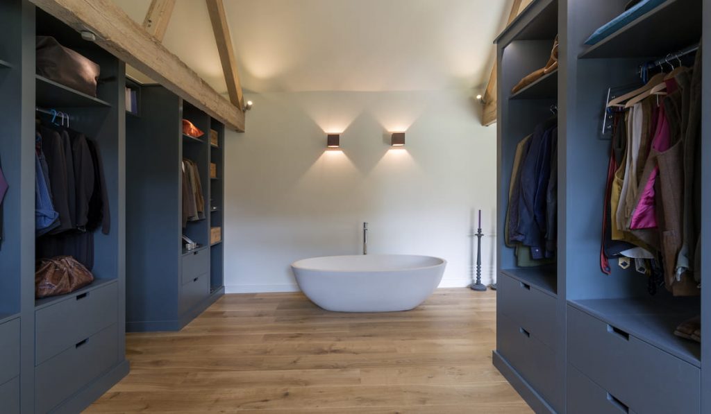 Closet and bathtub in modern bedroom