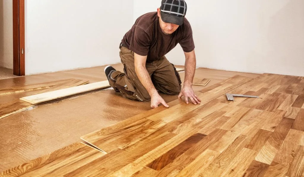 Craftsman installing engineered click system oak wood flooring
