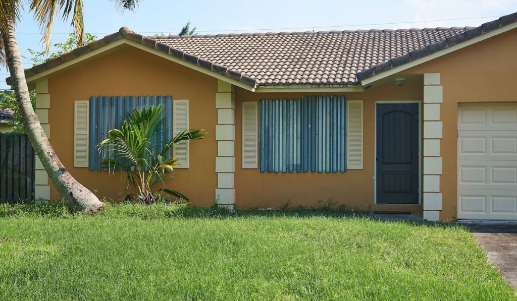 Hurricane Shutters on a Florida house. Storm panels cover the windows of a tropical home.

