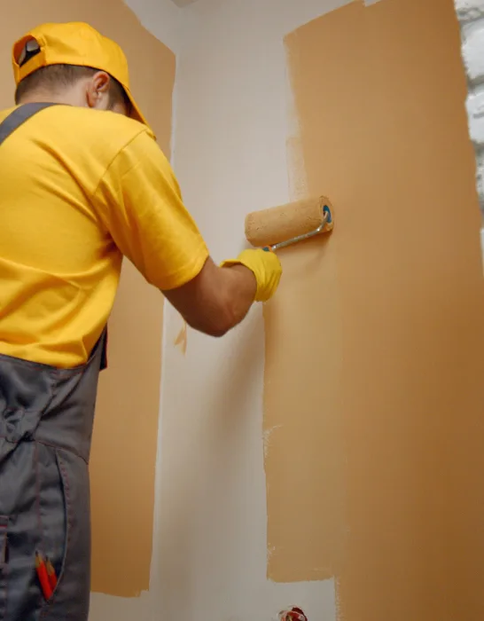 Worker-painting-wall-with-paint-roller