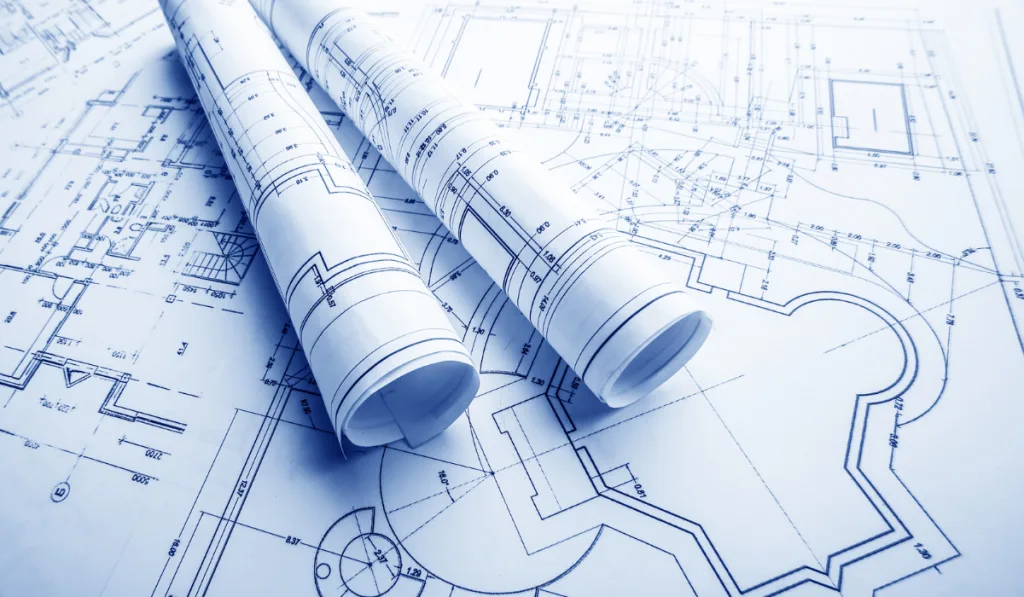 two rolled out floor plan on top of the laid out architectural plan. 