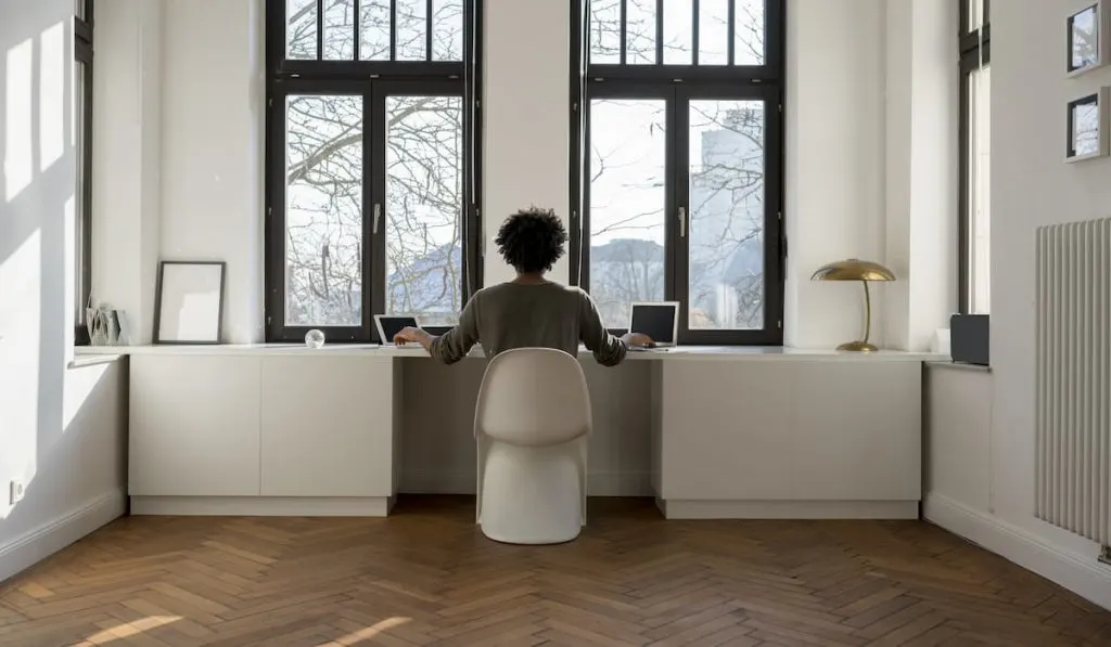 man working in front of impact window at home