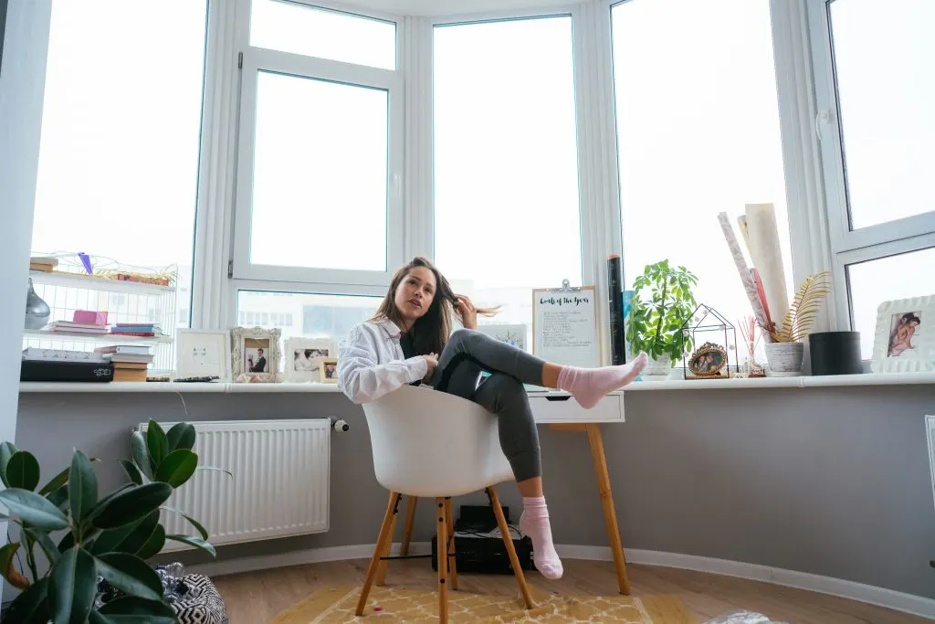 woman on chair near the impact window