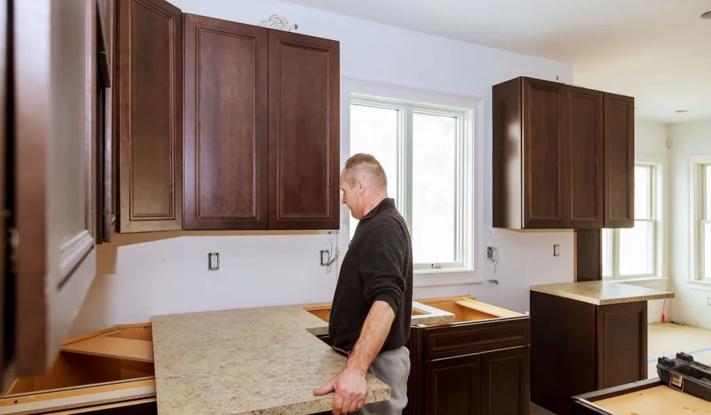 Contractor installing a new laminate kitchen counter top
