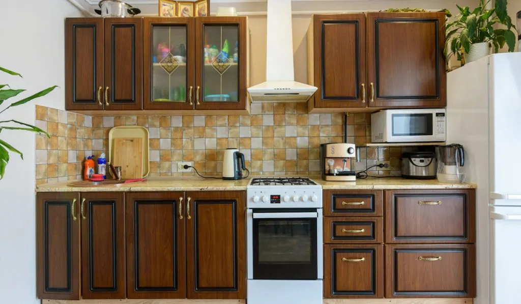 Kitchen set with appliances on dark wood in a standard apartment