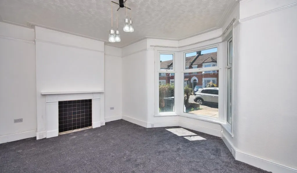 Old Victorian House Living Room Refurbished with Grey Carpet and Flash White Painted Walls 