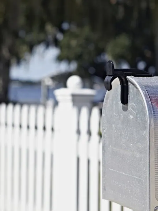 residential mailbox and a white fence
