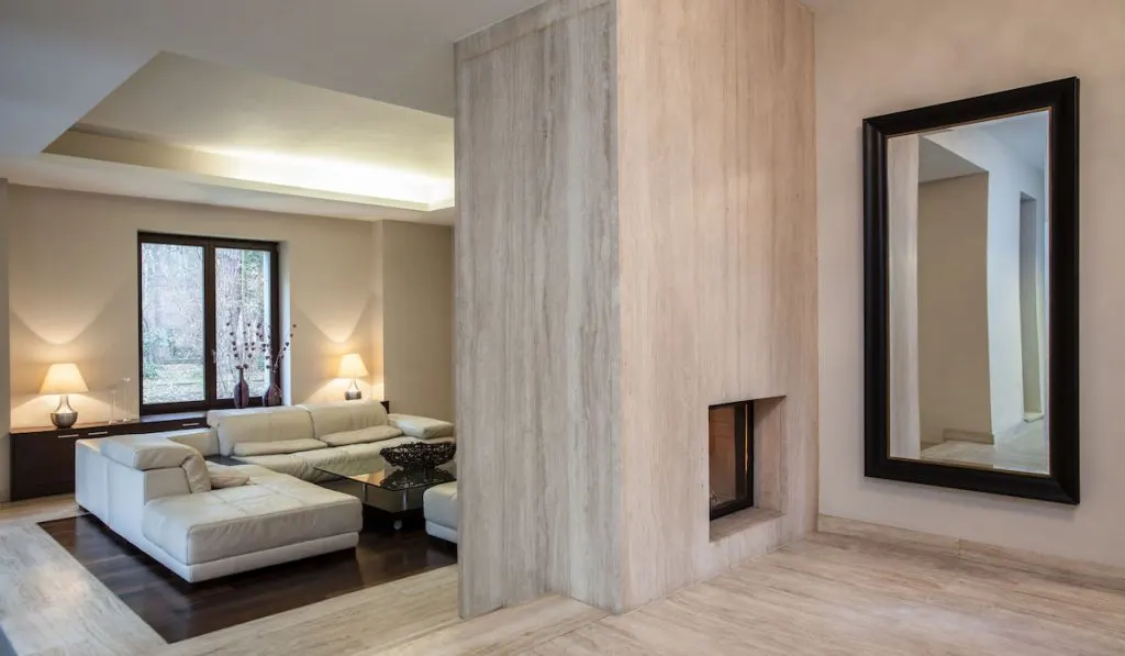 View of hallway and entrance to living room with large mirror on the wall