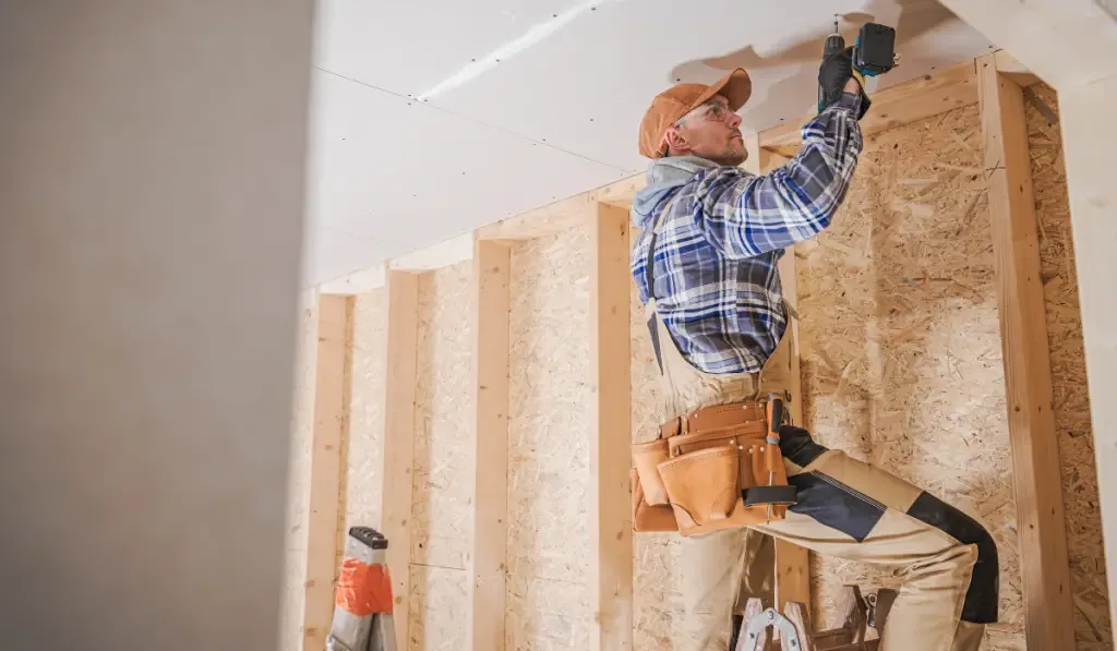 Worker Attaching Drywall