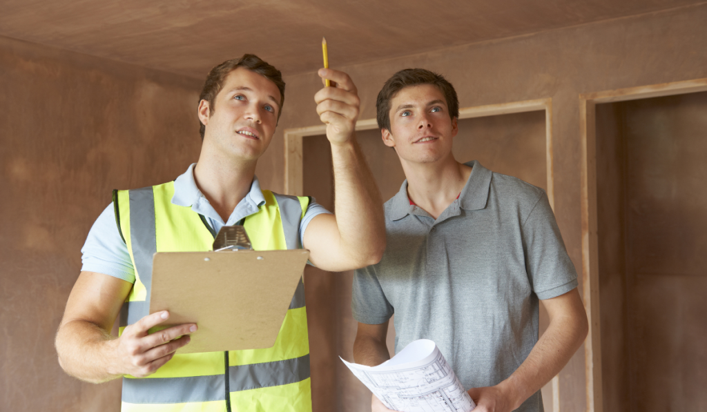 Builder And Inspector Looking At New Property
