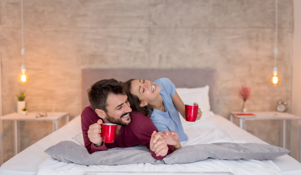 Couple drinking morning coffee in bed
