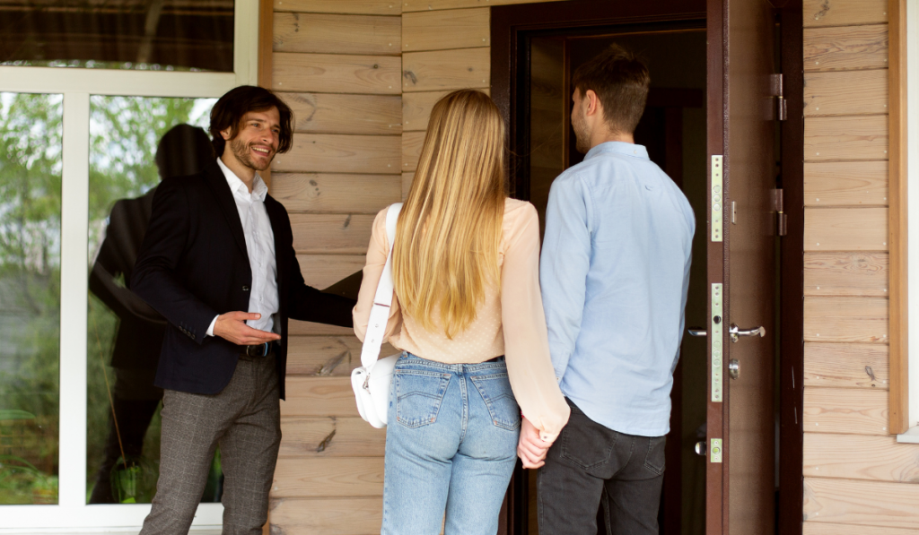 Property manager inviting potential buyers to enter house for sale