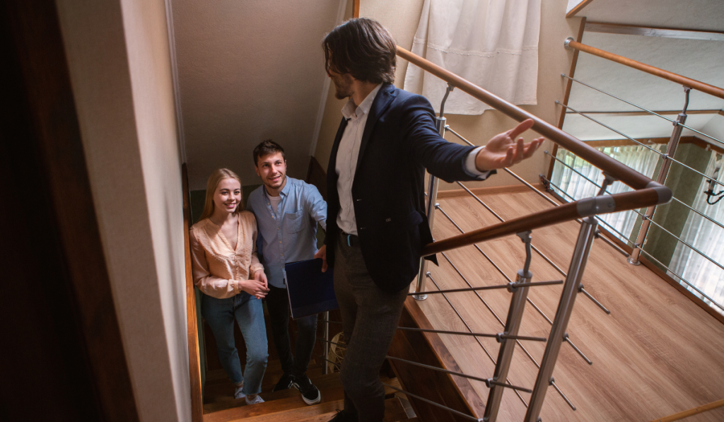 Real estate agent showing prospective buyers around property
