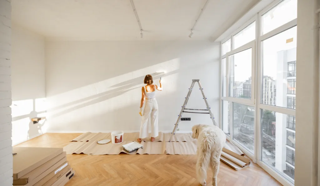 Woman with dog renovating house 